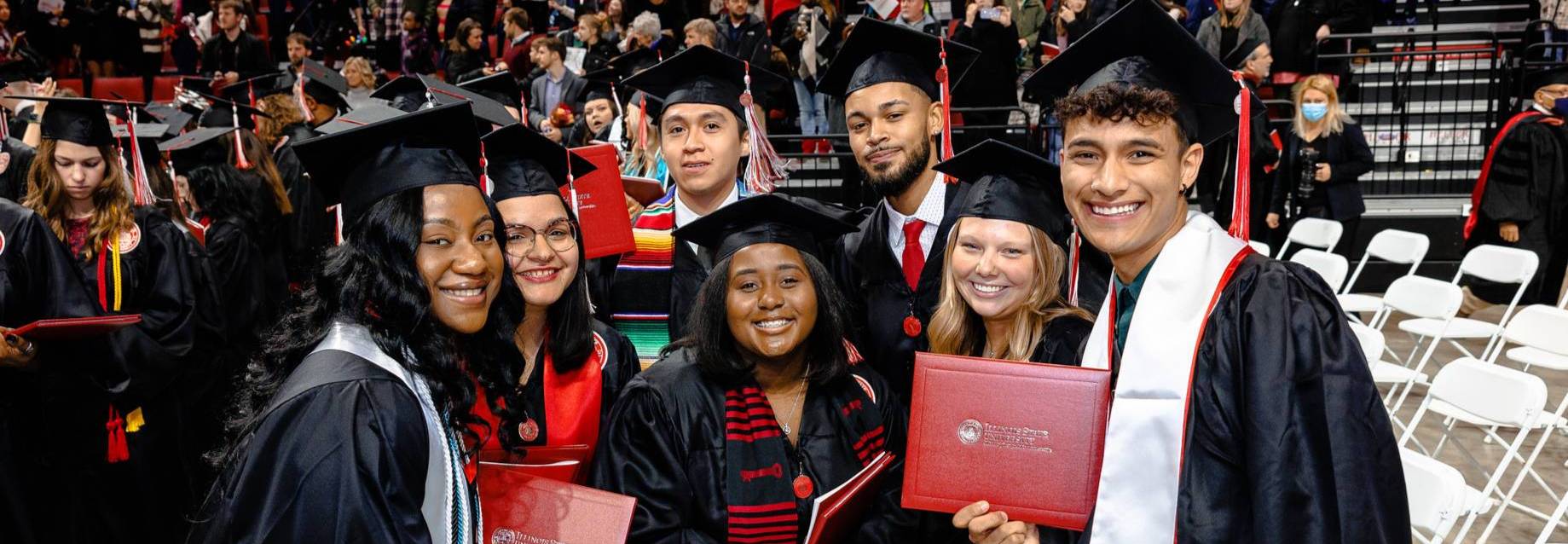 Group of graduates posing with diplomas at the graduation ceremony