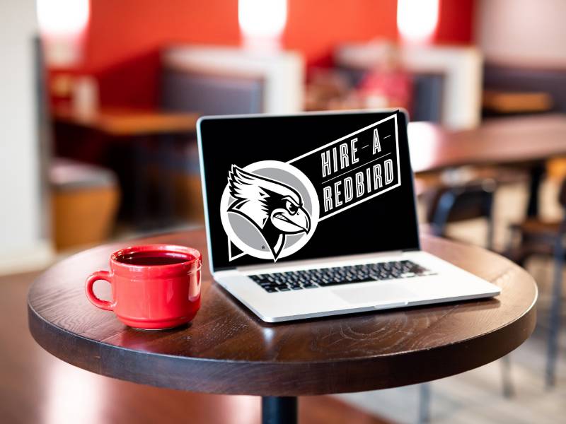 A laptop with a digital design showing Hire a Redbird