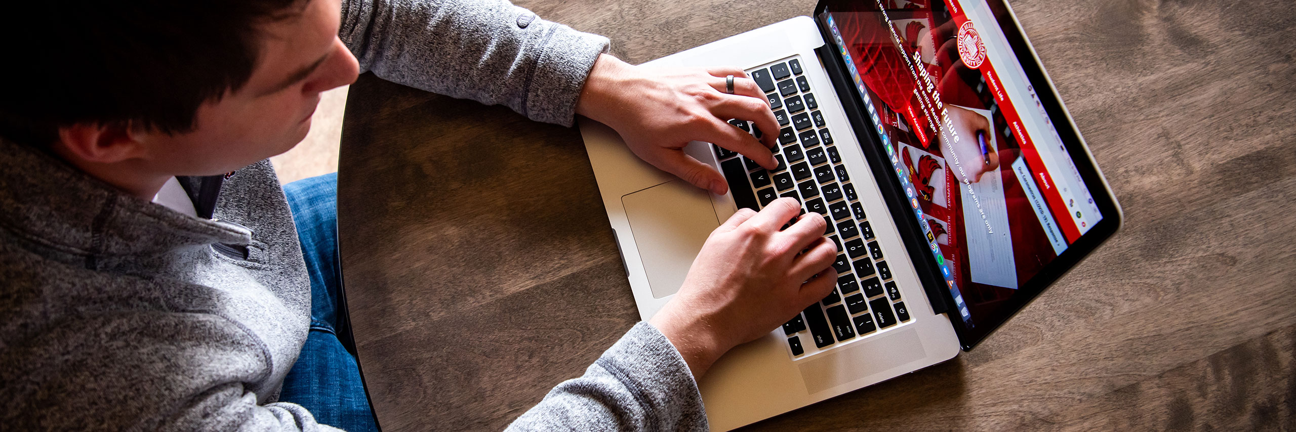 Student using a laptop in his dorm.